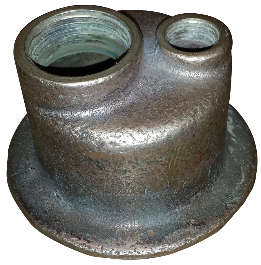 The original 1928 brass plumbing assembly responsible for the bottleneck.